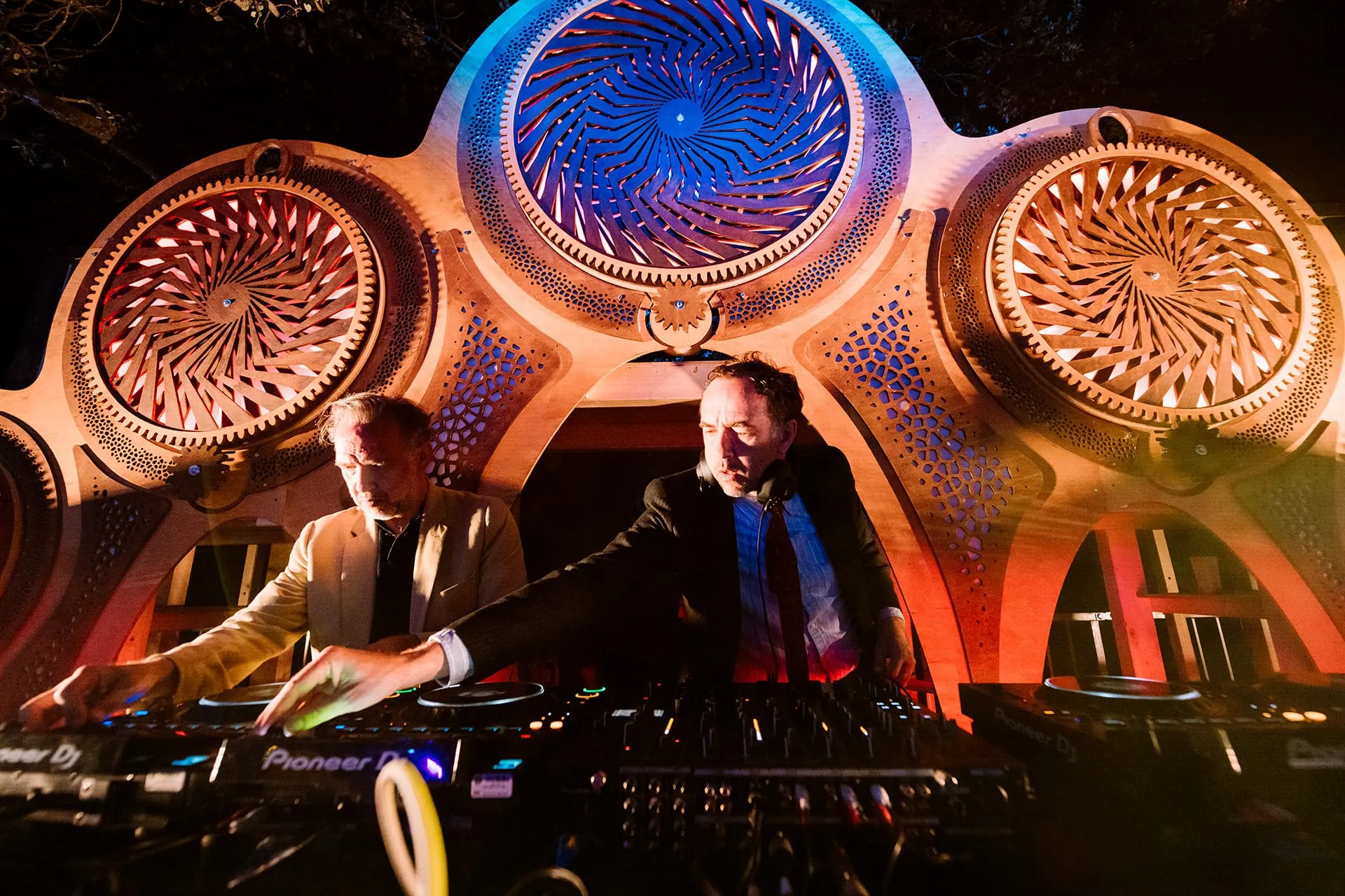 Delirium Festival – A kinetic stage of rotating, laser-cut mandalas – warm wood by day, a pulsing light machine by night.